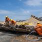 Researchers examining timbers from the shipwreck at the Cemex quarry site